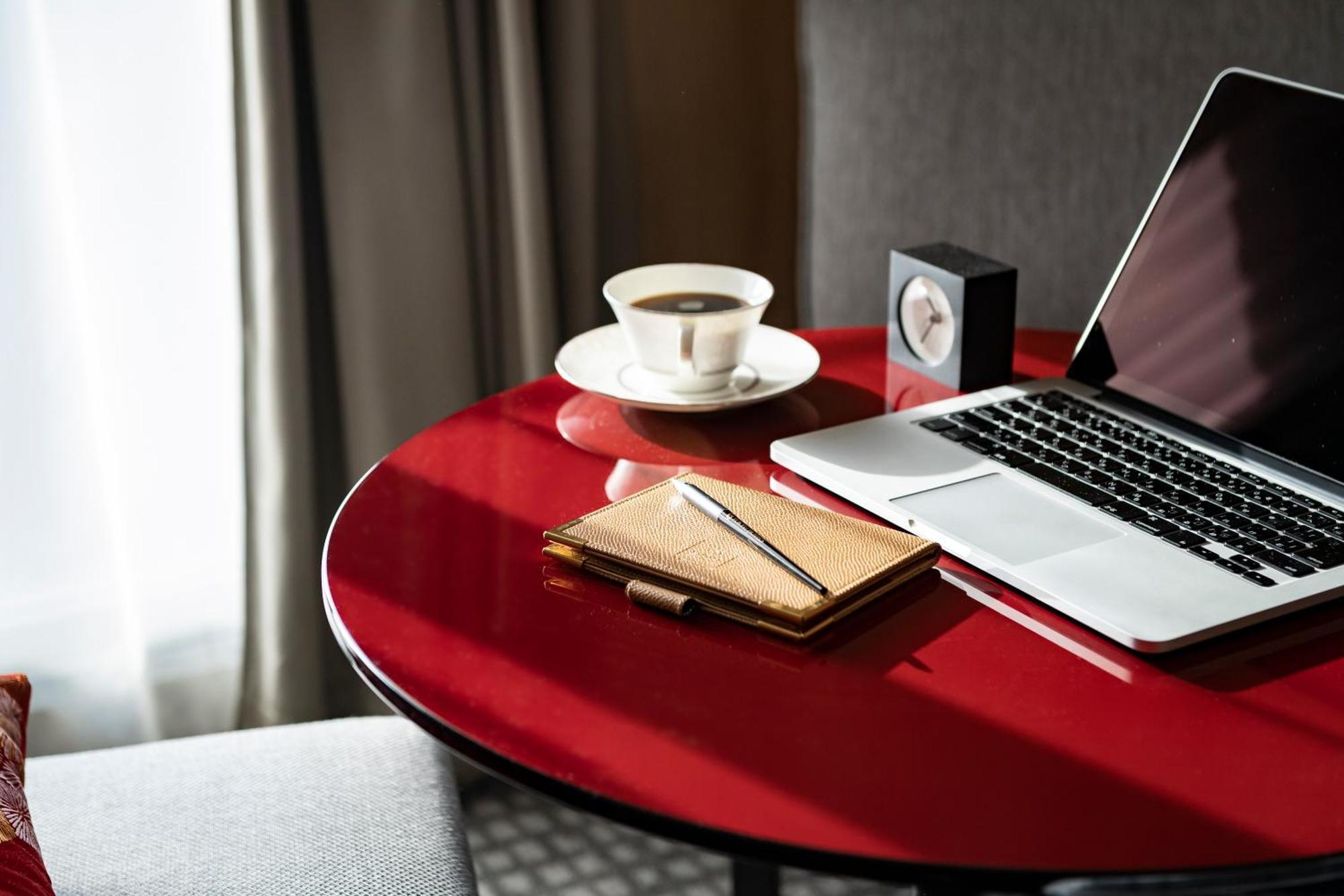 Kyoto Tokyu Hotel Exterior photo A table with a laptop, a cup of coffee, a notebook and a pen